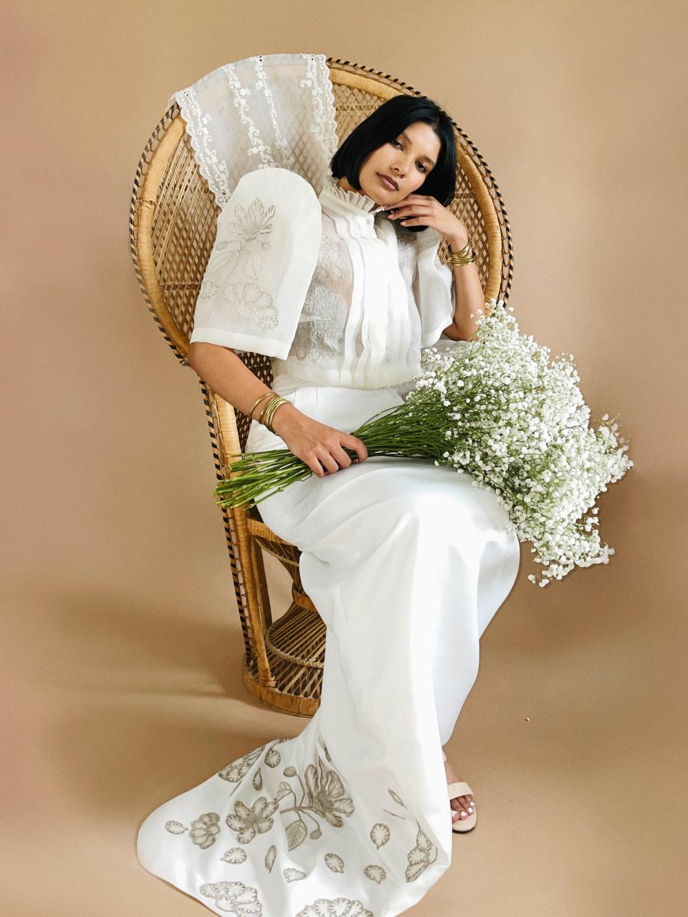 VINTA Banaba Flower High Neck Pleat Front Camisa and Saya de Cola, seated