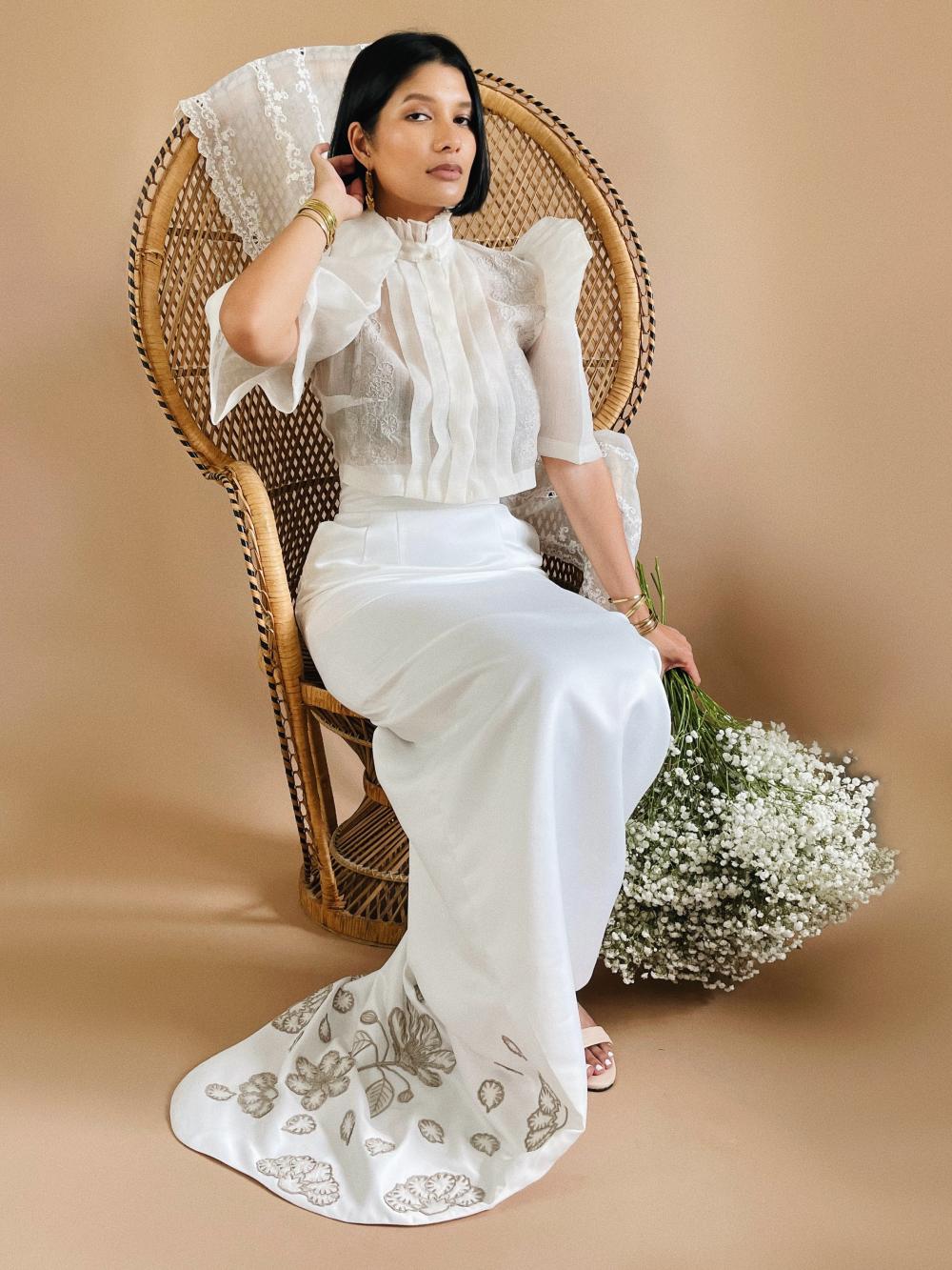 VINTA Banaba Flower High Neck Pleat Front Camisa and Saya de Cola, seated
