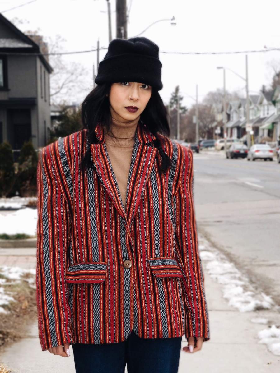 VINTA Unisex Oversized Ifugao Jacket, front view, buttoned, styled with black toque, camel turtleneck, and blue jeans