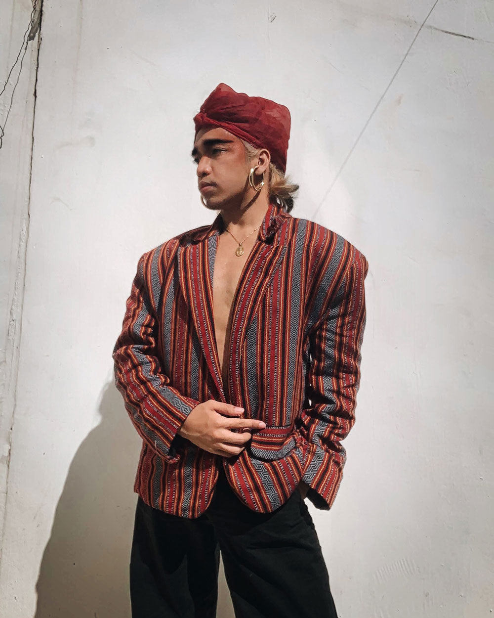 VINTA Unisex Oversized Ifugao Jacket, front view on male model, styled with deep red headscarf and gold hoop earrings