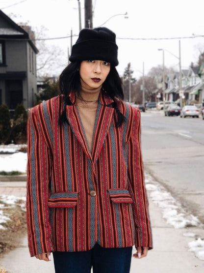 VINTA Unisex Oversized Ifugao Jacket, front view, buttoned, styled with black toque, camel turtleneck, and blue jeans
