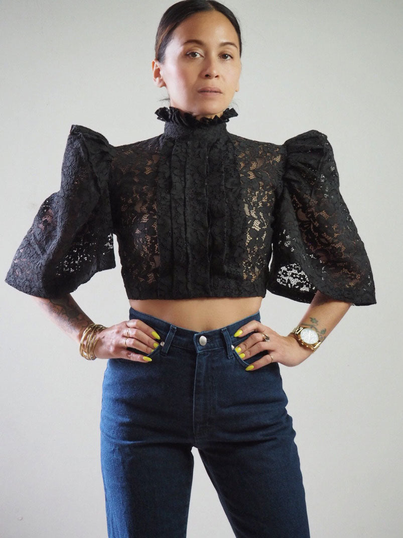 VINTA High Neck Pleat Front Camisa in Black, Styled with High Waisted Dark Denim Jeans, Models Hands on Hips